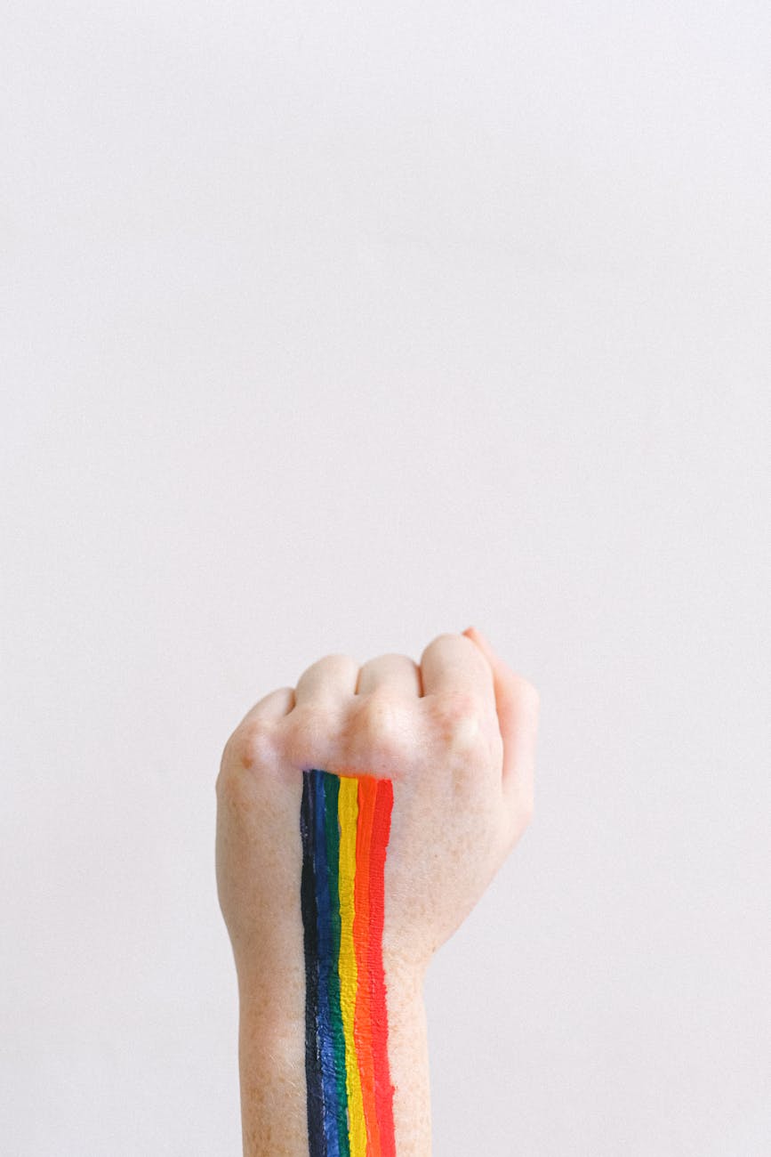 fist with a gay pride body paint