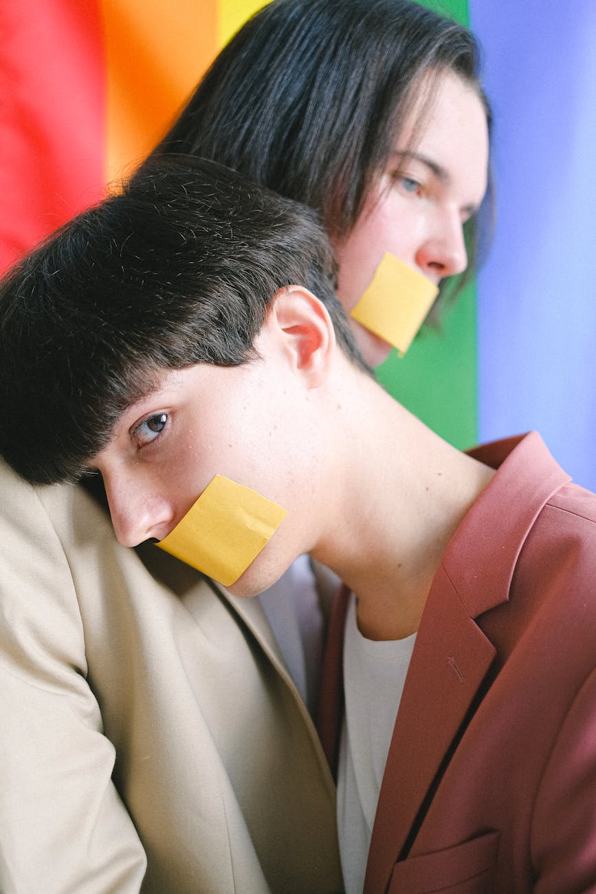 two men with adhesive tape over their mouth
