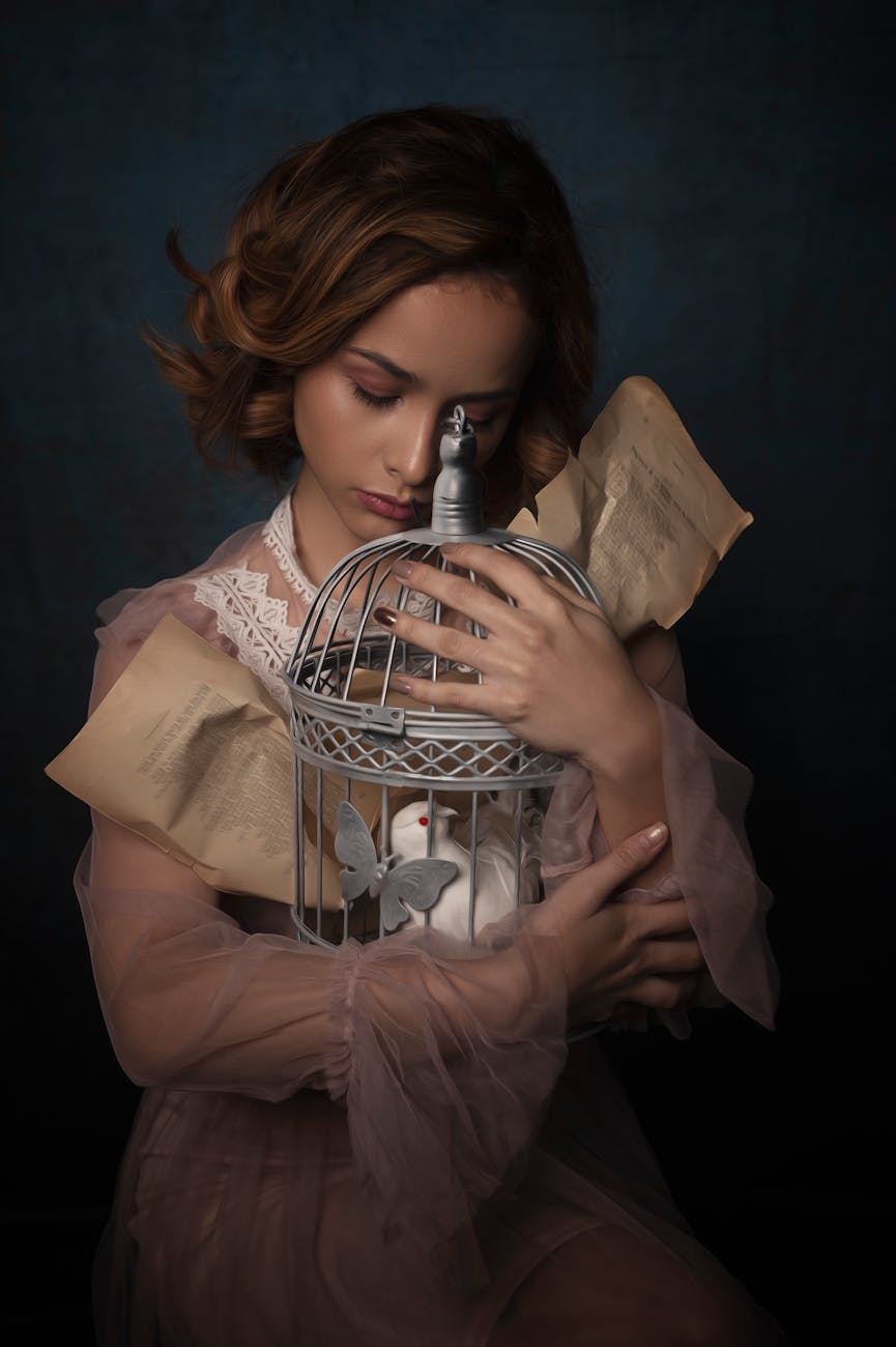 a woman embracing a bird cage