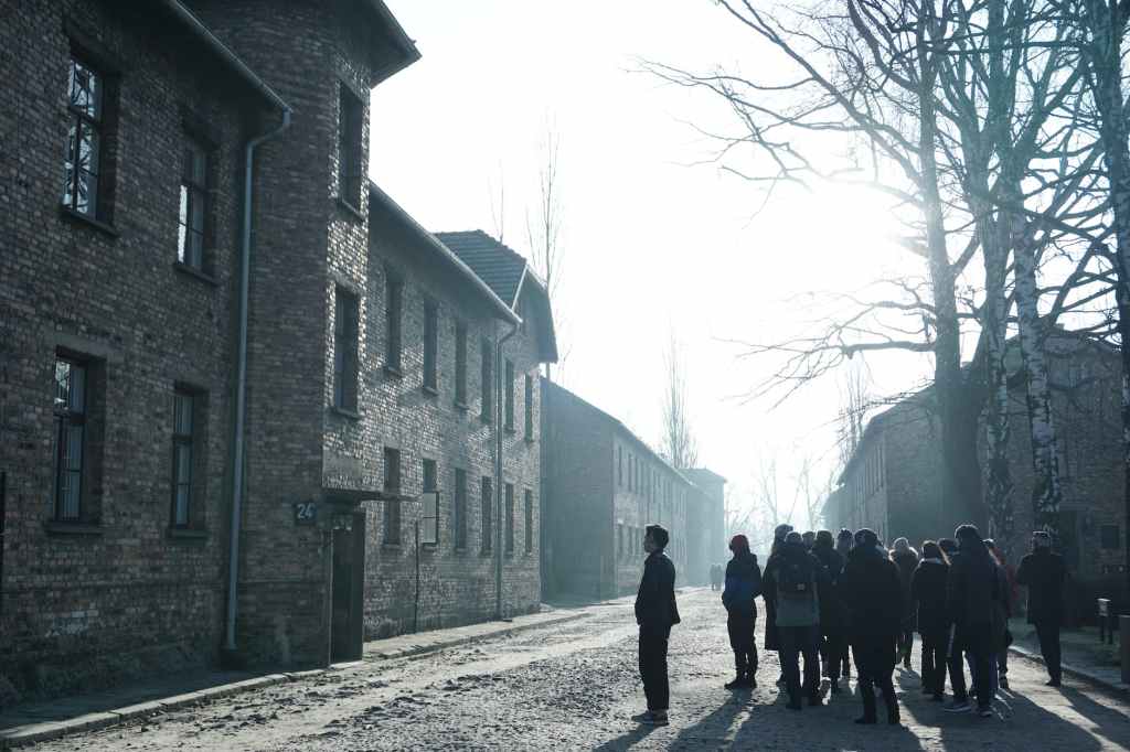 a group of people standing in front of a brick building
