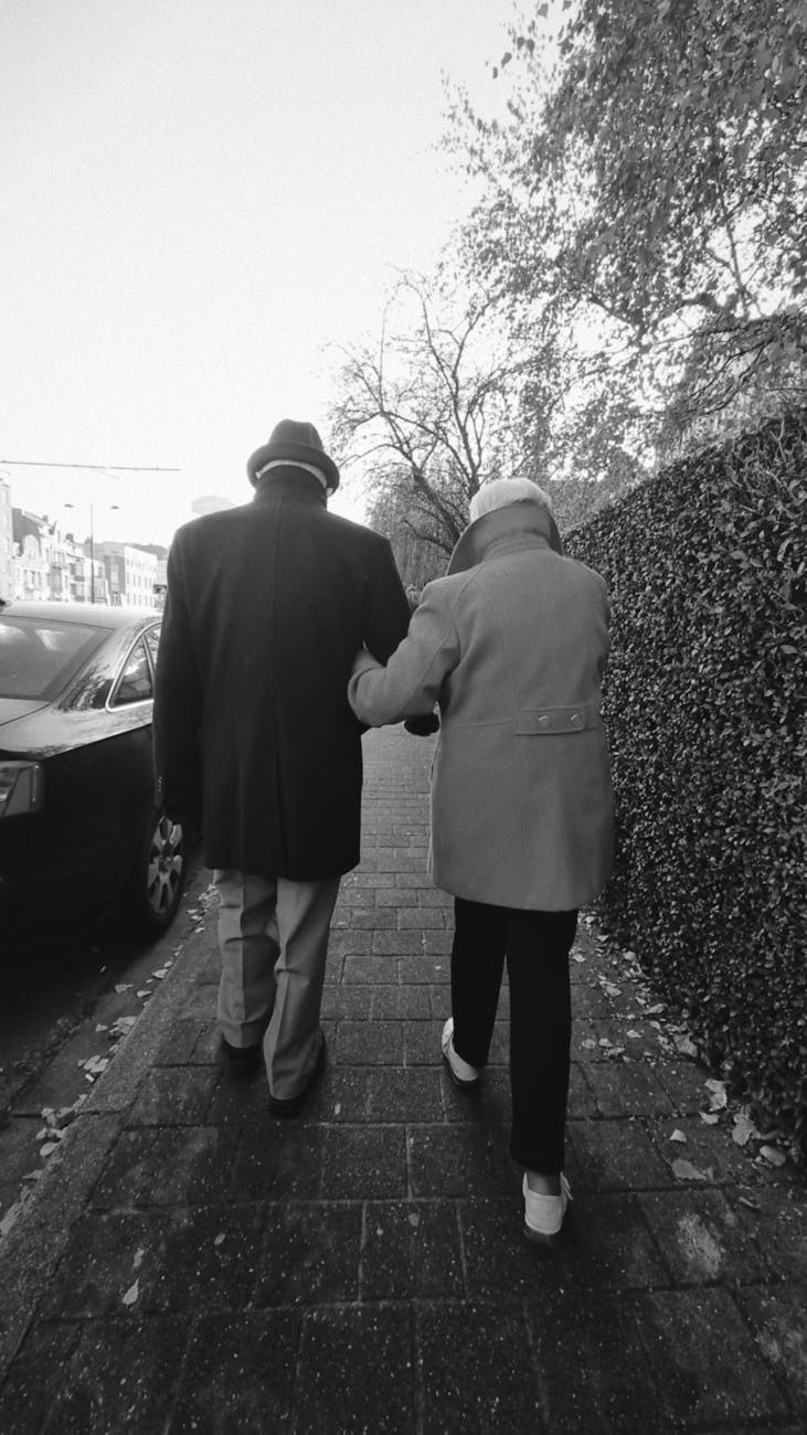 senior couple walking together holding each other